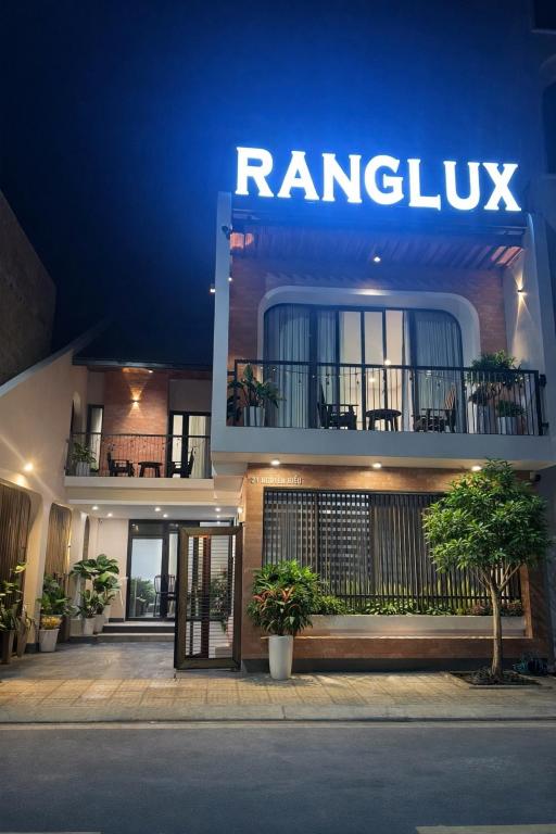 a building with a sign on the side of it at Ranglux Homestay Phan Rang in Phan Rang–Tháp Chàm