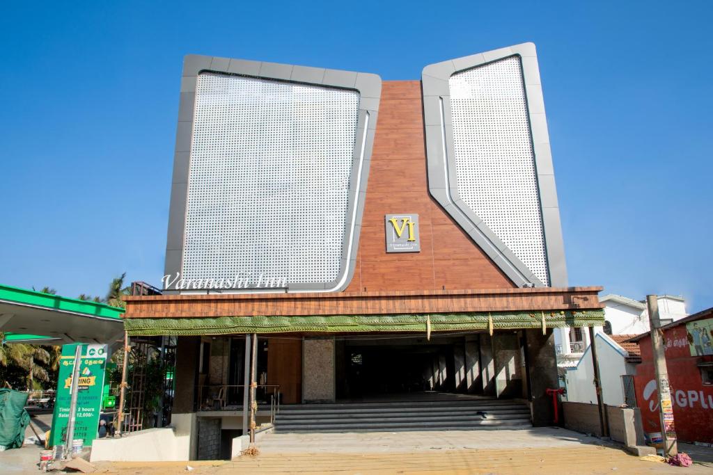 a building with two large windows on top of it at Varanashi Inn in Tiruppūr