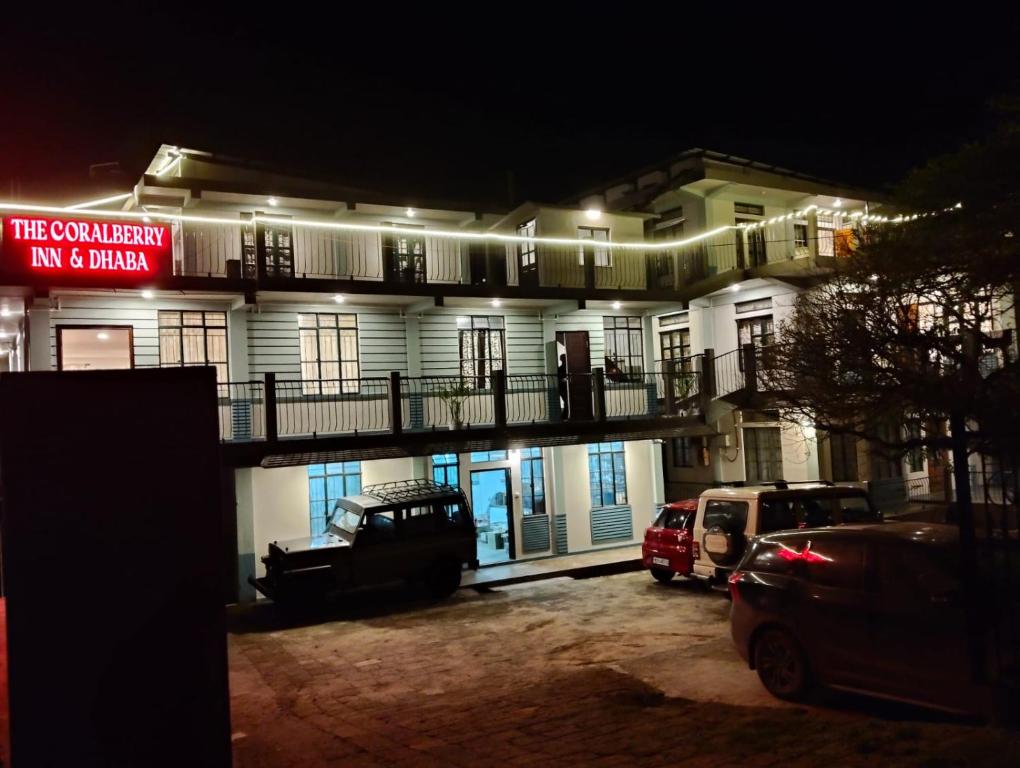 a building with a parking lot in front of it at Coralberry Inn in Jāmb