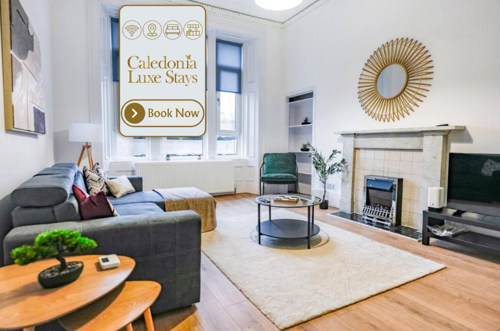 a living room with a blue couch and a fireplace at Cambridge Apartment in Glasgow