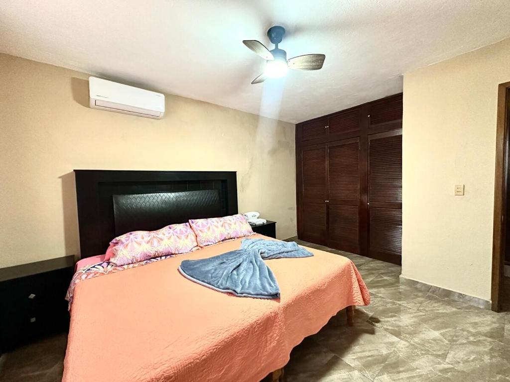 a bedroom with a bed and a ceiling fan at Colimota in Colima