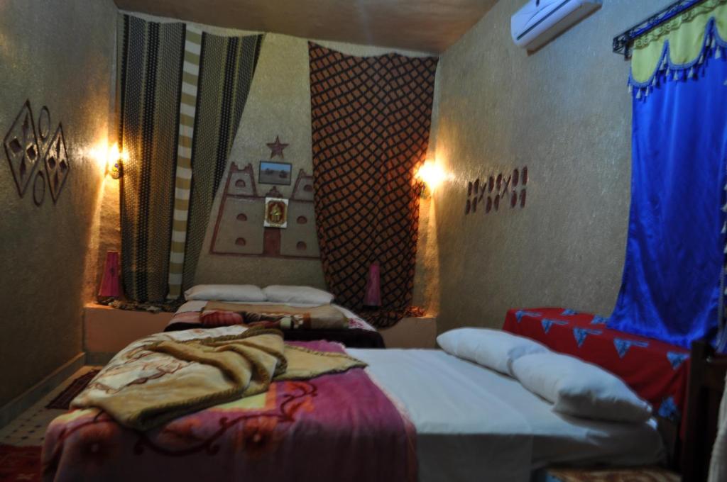 Postel nebo postele na pokoji v ubytování Riad Aicha & Camel Trekking
