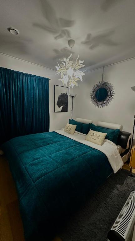 a bedroom with a large bed with a blue blanket at 2bedroom apartment in Haninge in Mårtensberg