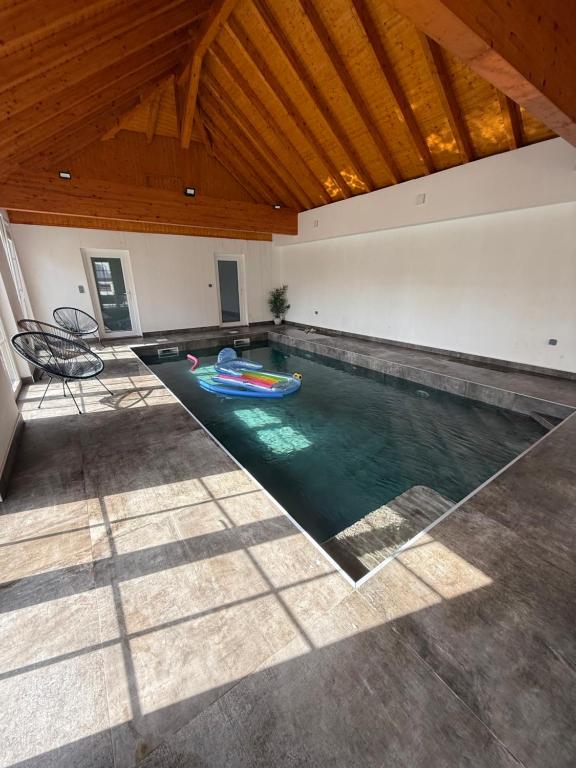 an indoor swimming pool with a boat in a house at L ecrin de Rosheim, villa d exception, piscine in Rosheim