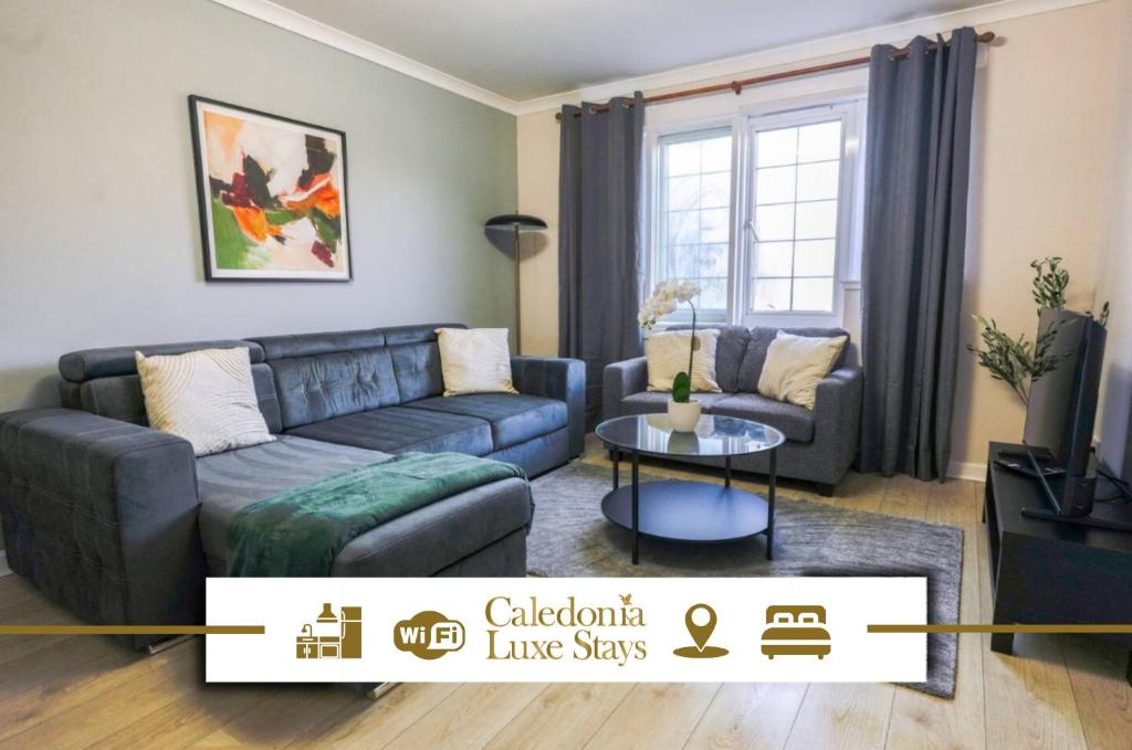 a living room with a couch and a table at Burnvale Apartment in Livingston