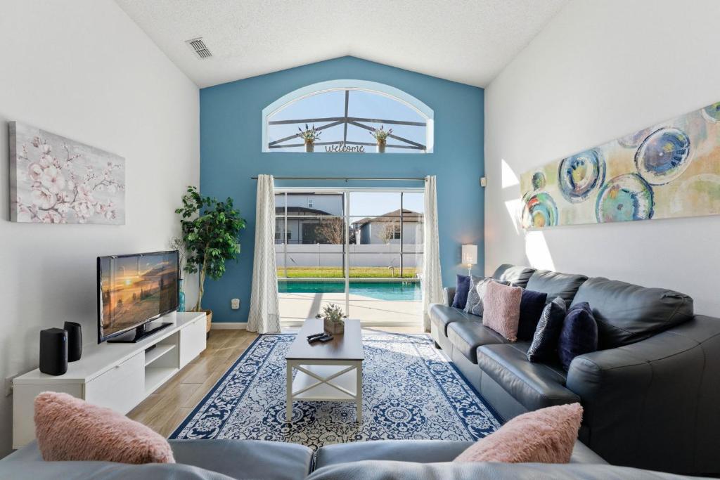 a living room with a couch and a tv at 4 BR No carpet Just Remodeled Unit SR1205 in Kissimmee