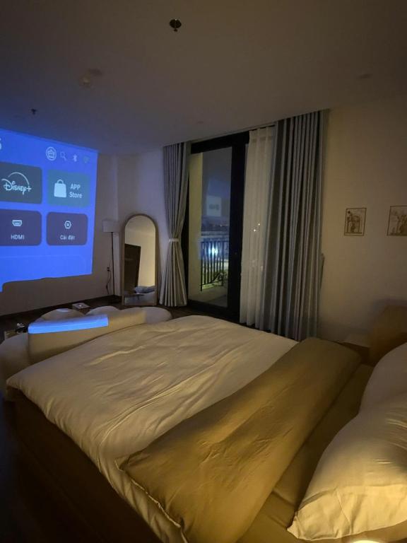 a bedroom with two beds and a large window at LucyHouse in Thôn Trường Giang