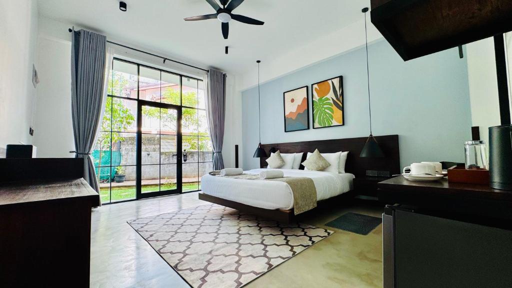 a bedroom with a bed and a large window at Humble Ella in Ella