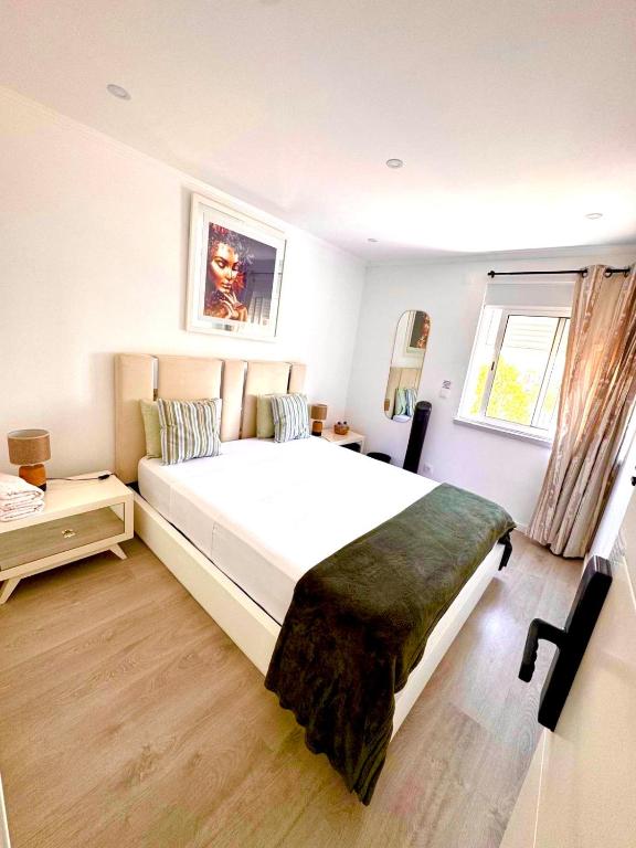 a bedroom with a large bed and a window at Quarto Aeroporto in Lisbon