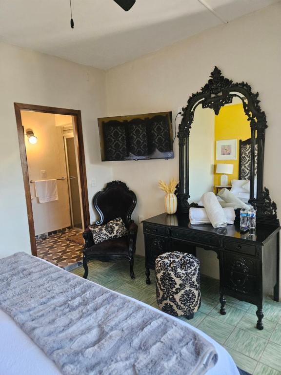 a bedroom with a dresser and a mirror and a bed at Casa Mestiza in Guadalajara