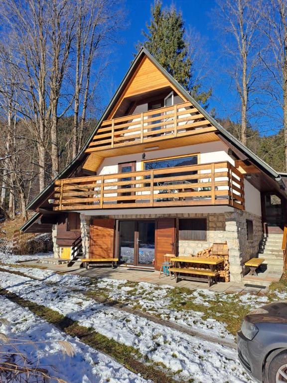 a large log cabin with snow on the ground at House Nordika in Rateče