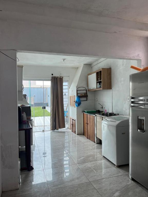 a kitchen with a refrigerator and a counter top at Casa Gui in São Gabriel