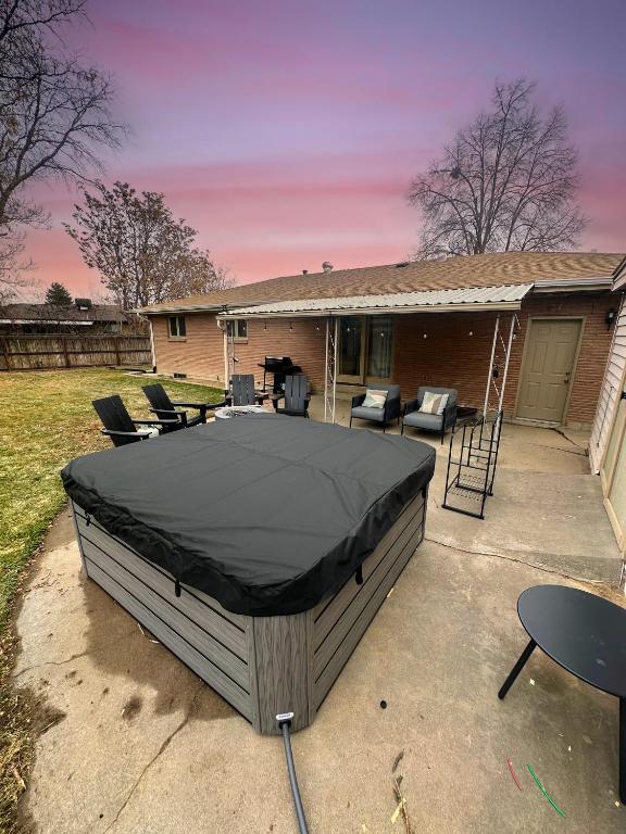 a bed in the backyard of a house at Denver Hot Tub Retreat Near Downtown Denver-Stadiums-Bellco in Westminster