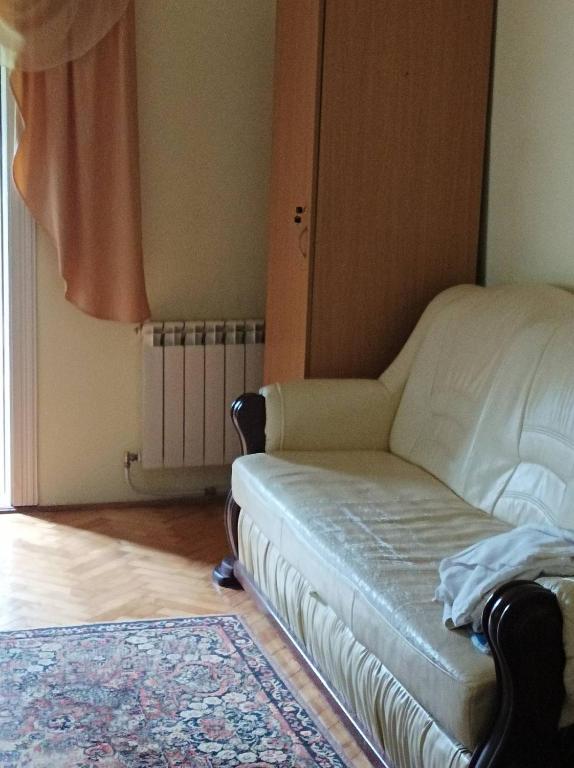 a living room with a couch and a window at Ольга in Ogrody