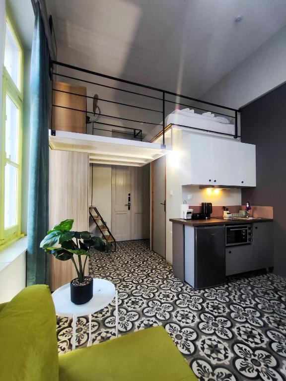 a kitchen and a living room with a plant at Apartment Studio 7 in Mytilene