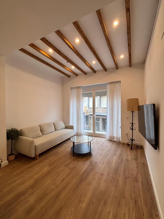 a living room with a couch and a tv at Cuatro Cantillos in Aguilar de la Frontera