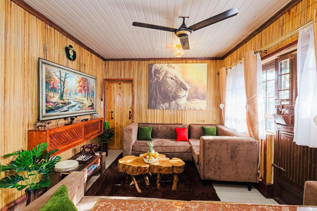 a living room with a couch and a table at The Kimaru Cottage in Ngong
