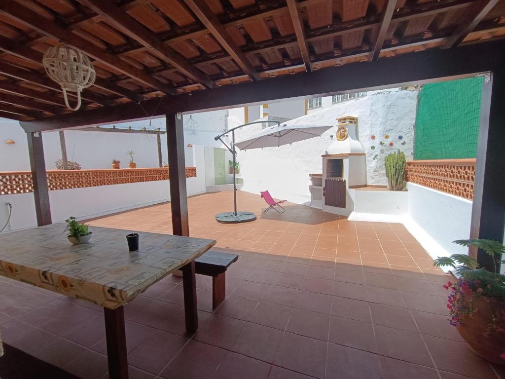 a room with a table and an umbrella on a patio at MiRaRio in Vila Nova de Milfontes