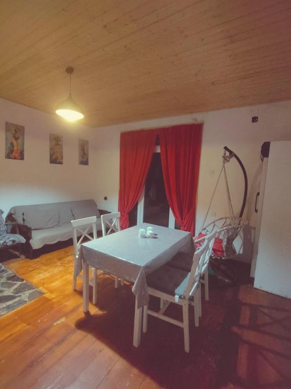 a living room with a table and a couch at Apartment of mestia in Mestia