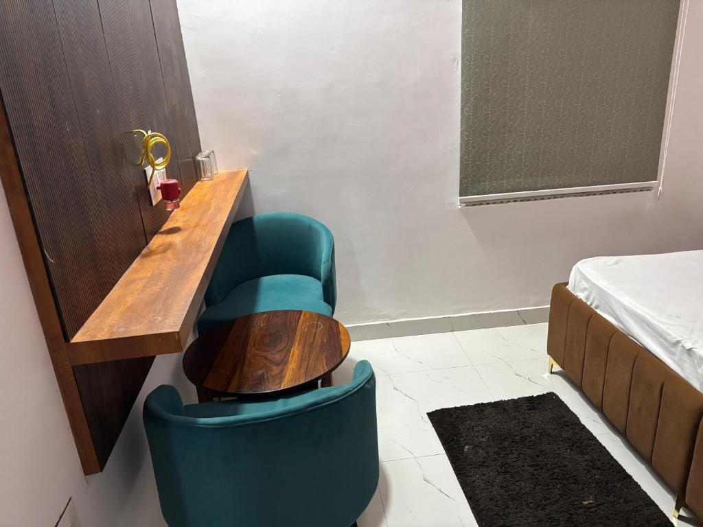 a room with a wooden table and a blue chair at hotal shahi palace in Jodāsar