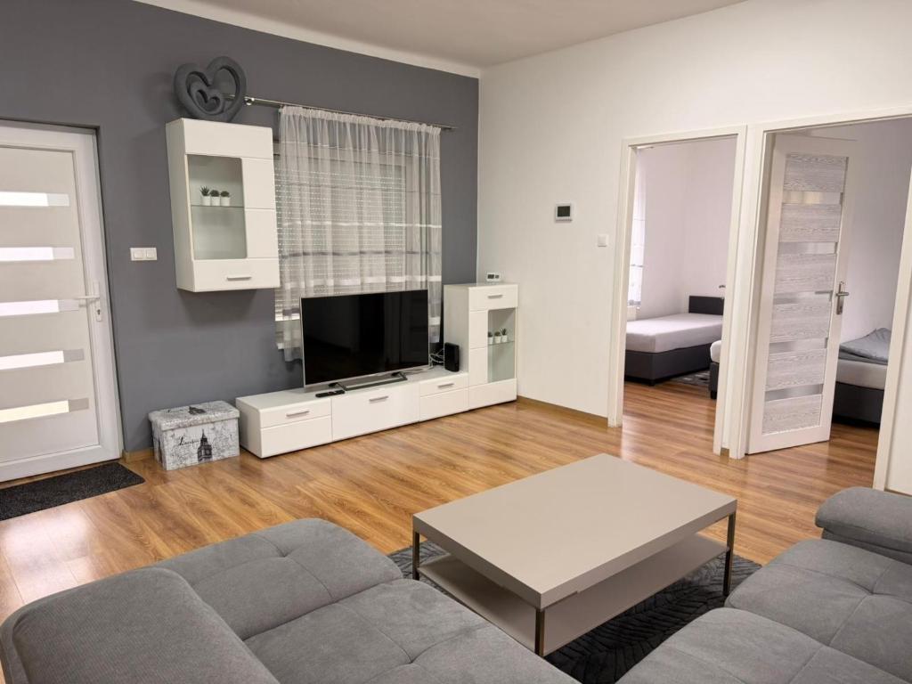 a living room with a couch and a tv at BE-LE-VALÓ APARTMAN in Szécsény