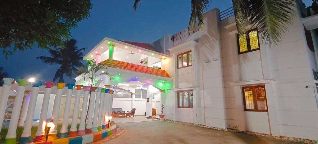 a white house with a fence in front of it at Sangeetha Private Pool Villa in Auroville