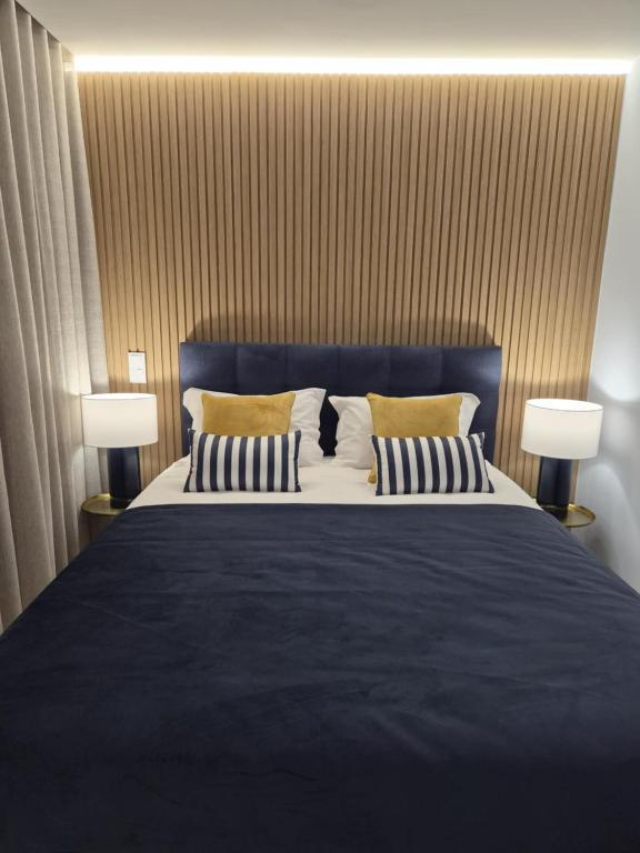 a bedroom with a large bed with two lamps at Hotel Buganvília in Funchal
