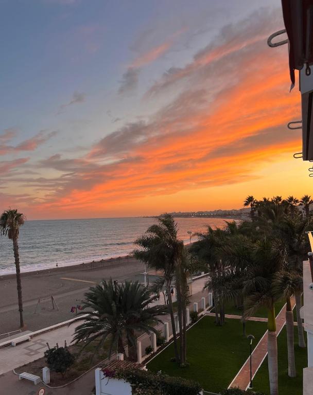 a view of the beach at sunset from a building at New Caleta apartment seaviews in Caleta De Velez