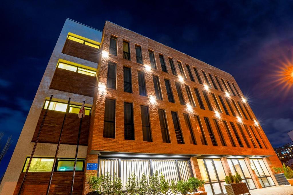 a tall brick building with lights on it at Hotel Tiflida in Tbilisi City