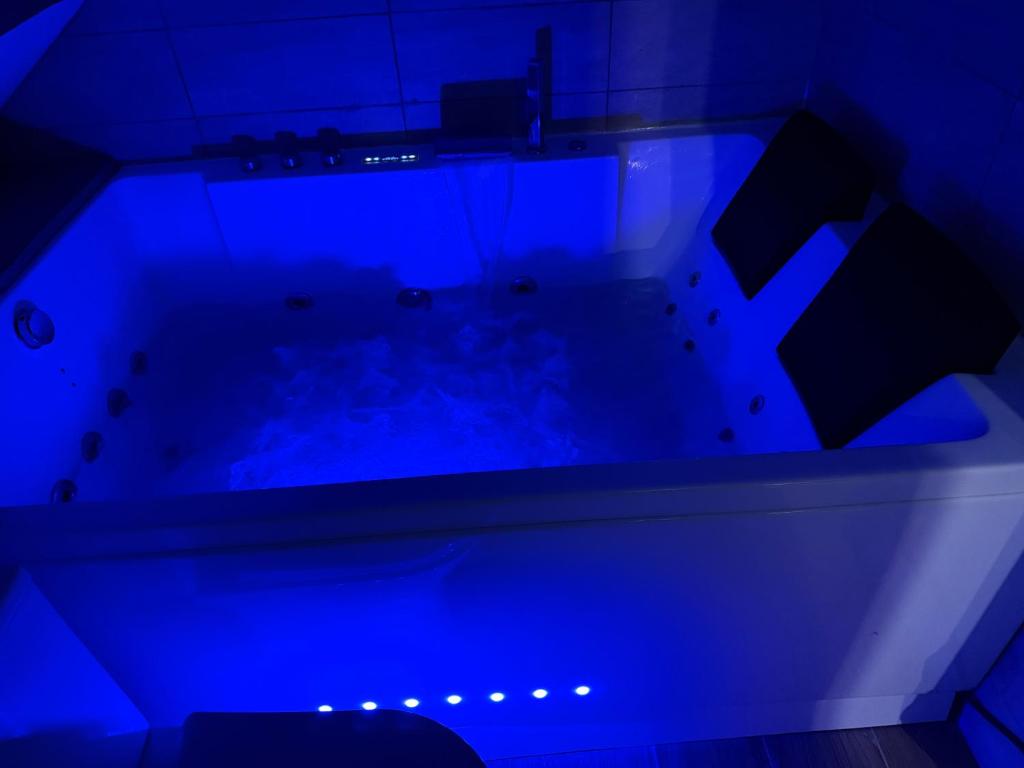 a blue lighted bath tub in a bathroom at Titi90 in Belfort