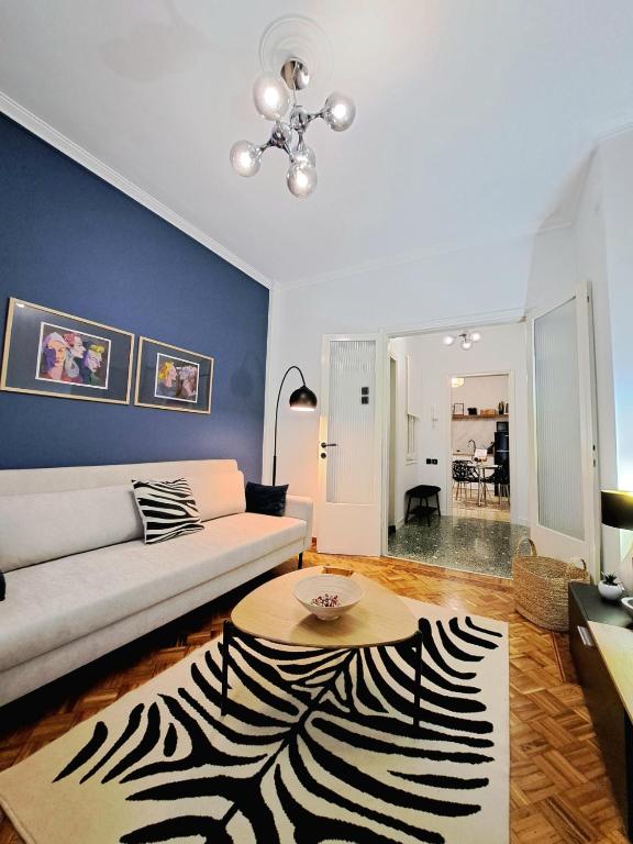 a living room with a couch and a zebra rug at Stylish City Center Apartment - with FREE PARKING space -not for big cars- 200m away in Serres