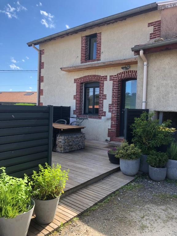 a wooden deck in front of a house at Gîte de chenieux in Saint-Victor-sur-Loire