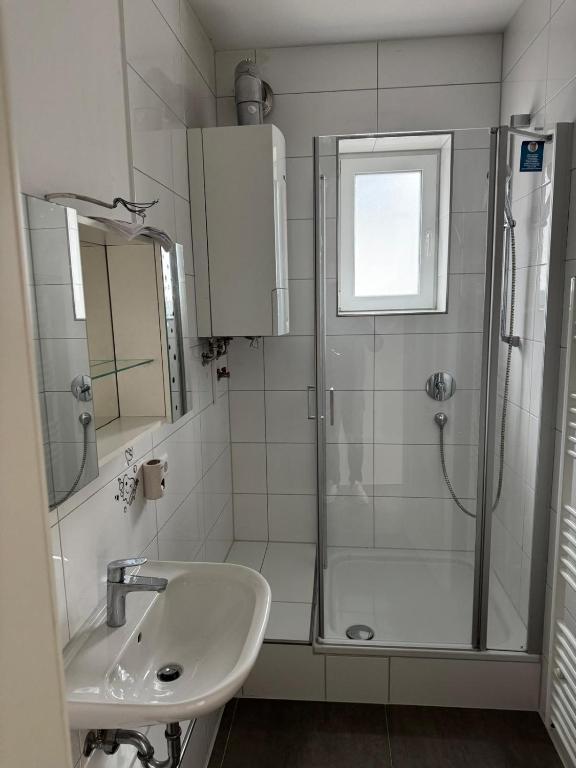 a bathroom with a shower and a sink at Sia Apartment in Stuttgart