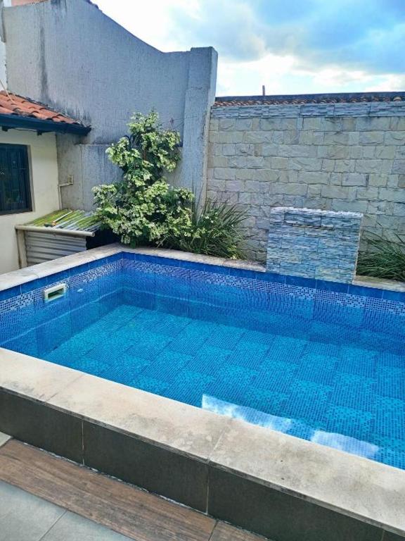 a swimming pool in front of a building at La casa de Nimia in Asunción