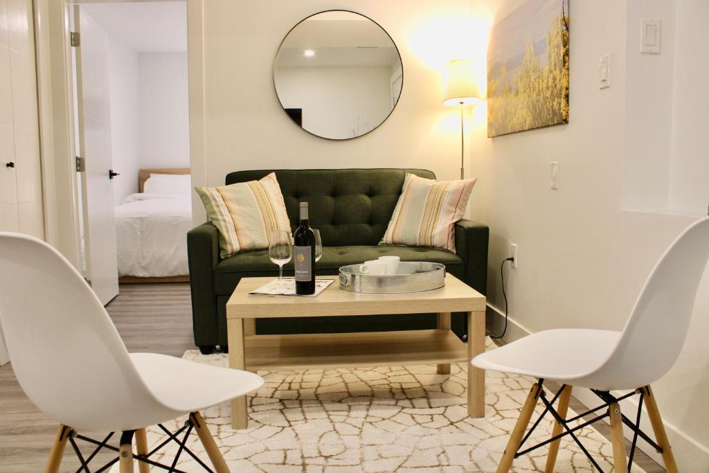a living room with a green couch and a table at 2BDR Stylish Comfort Parkside in Vancouver