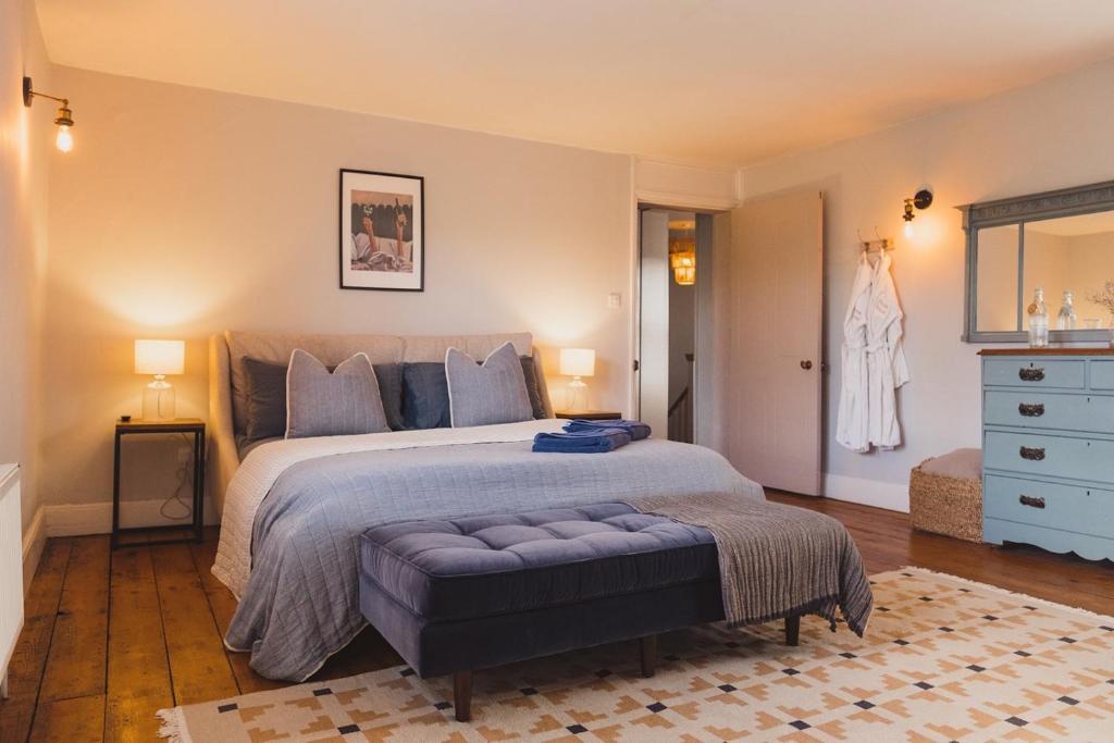 a bedroom with a large bed and a blue dresser at Luxury House sleeps 14 with Secret Bar near Bath in Warminster