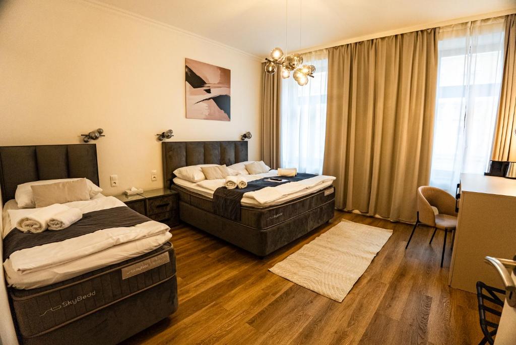 a hotel room with two beds and a window at Arte Brno in Brno