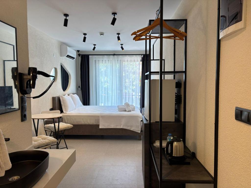 a bedroom with a bed and a bathroom at Arıcan Pansiyon in Fethiye