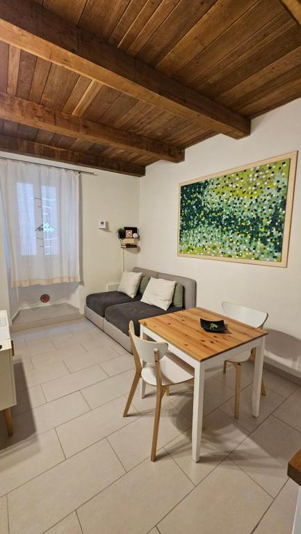 a living room with a table and a couch at TorreCielo in Foligno
