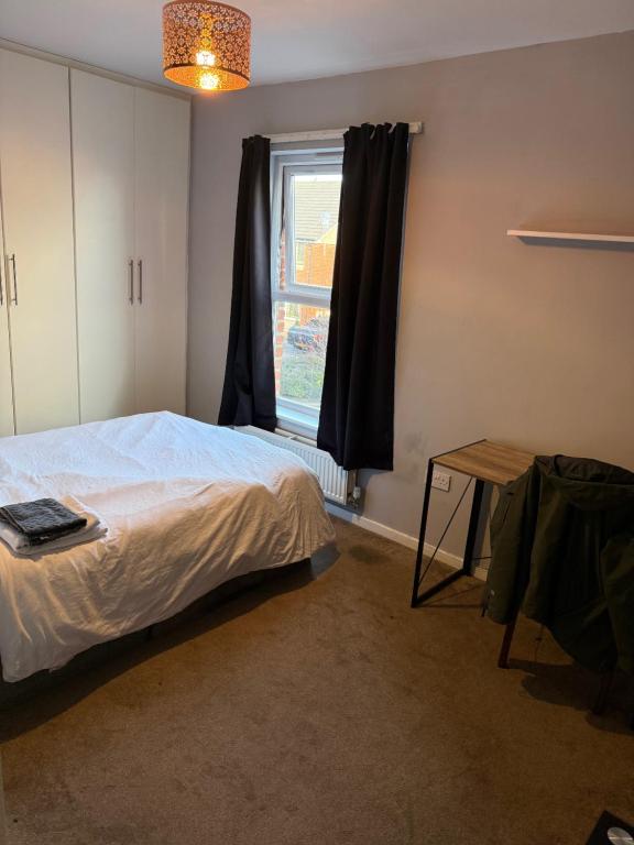 a bedroom with a bed and a window at STOCKTON CONTTRACTOR DIGs in Stockton-on-Tees
