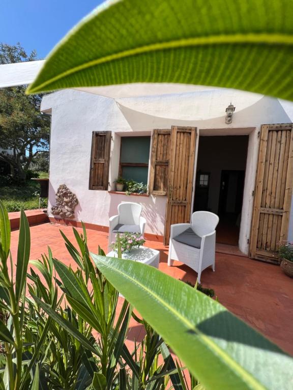 a small white tent with two chairs on a patio at Il Lentischio Casa 3 in Nulvi