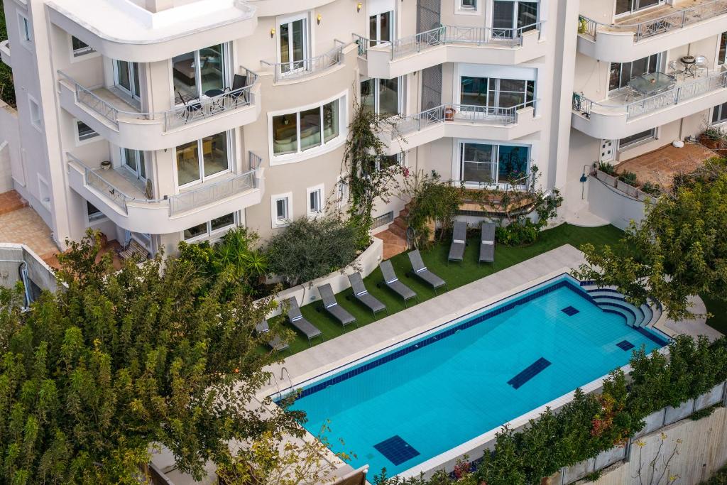an aerial view of an apartment building with a swimming pool at Villa Bijoux SeaView Pool near Athens airport in Neos Voutzas