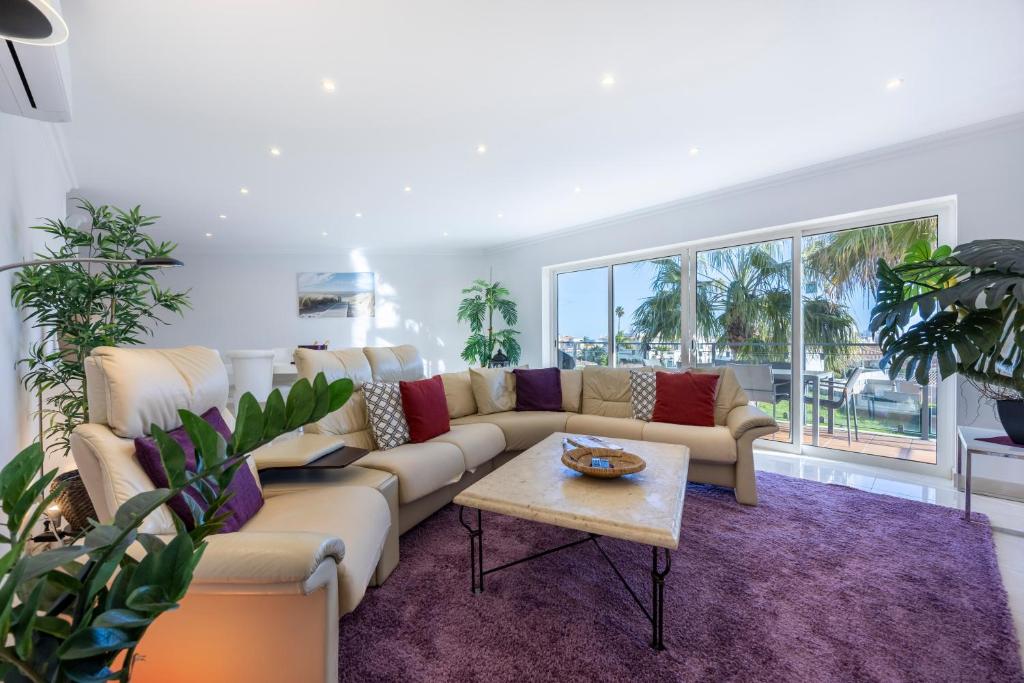 a living room with a couch and a table at Infinity Penthouse in Lagos