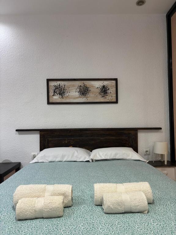 a bedroom with a bed with two towels on it at The Ruzafa by Laura - AVE in Valencia