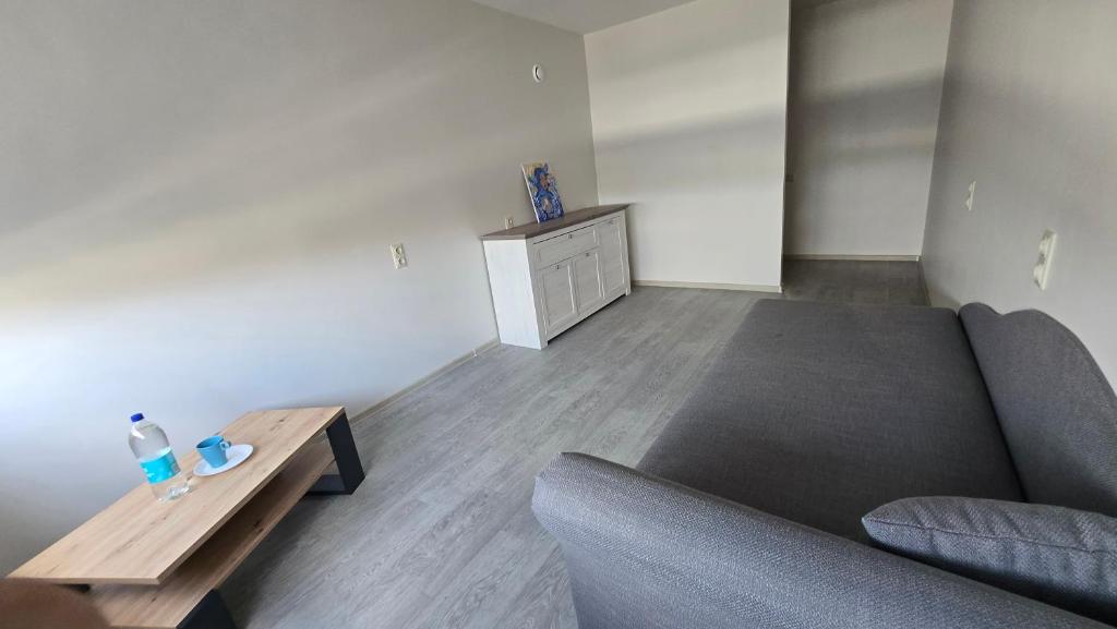 a living room with a couch and a coffee table at Hostel istaba in Rēzekne