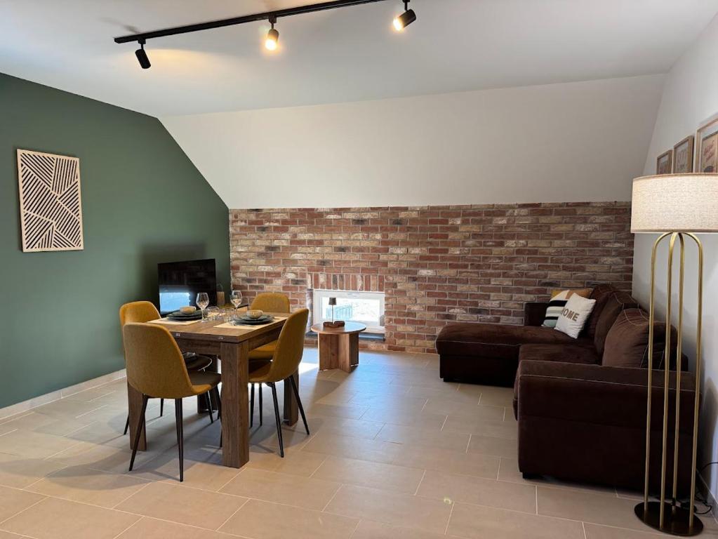 a living room with a table and a couch at Appartement à Ohain in Ohain