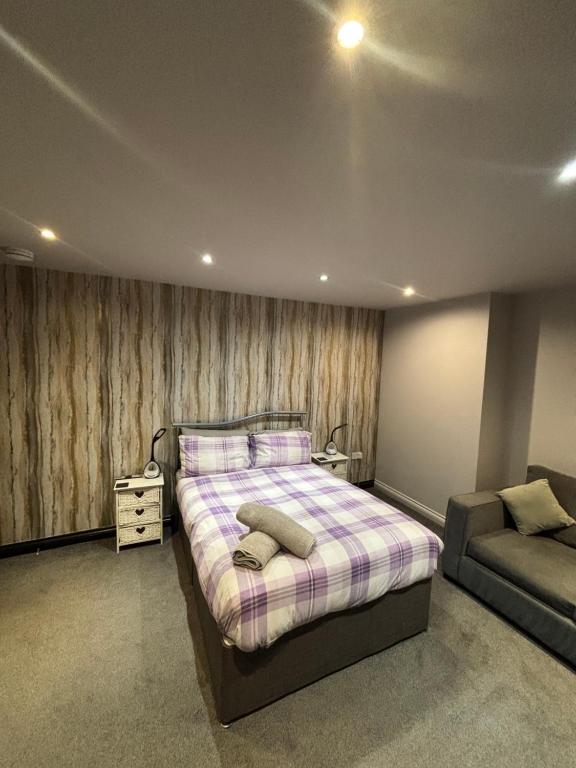 a bedroom with a large bed and a couch at Airport Tavern Accommodation in Felton