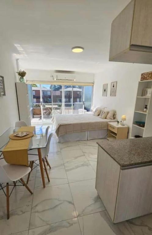 a living room with a bed and a table at Apartamentos del campus in Presidente Derqui