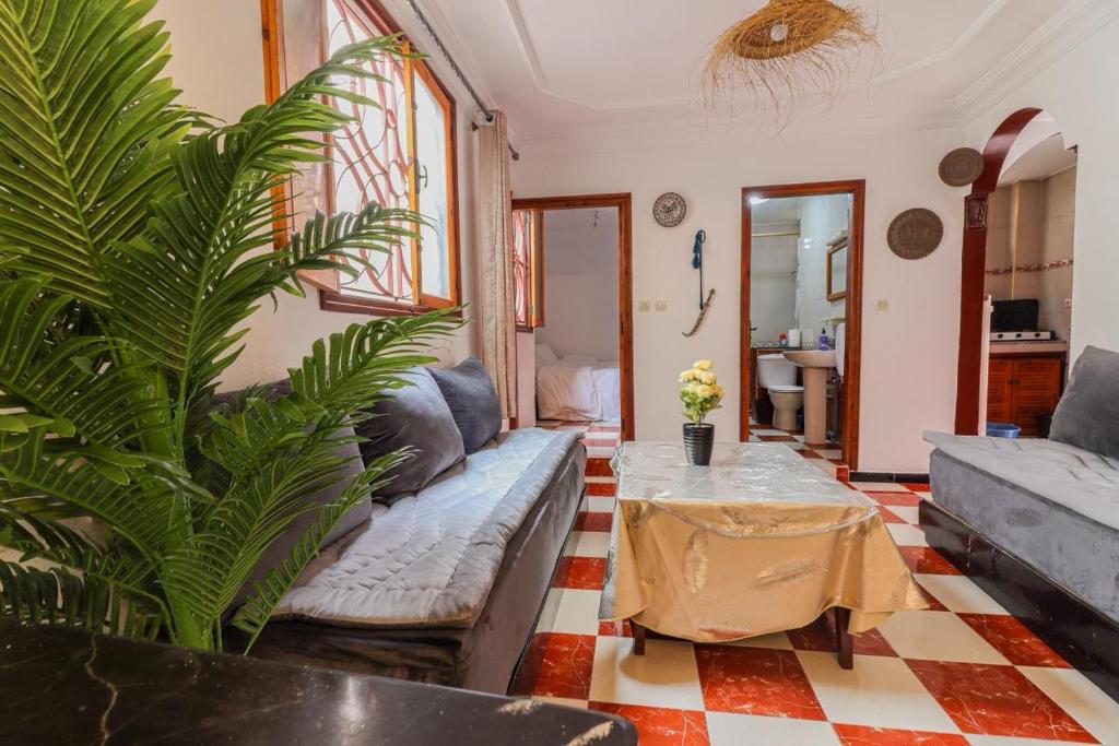a living room with a couch and a table at Appartement calme et ensoleillé avec WiFi haut débit in Sidi Ifni