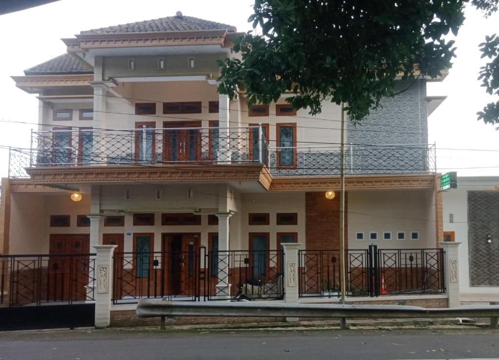 a large house with a balcony on top of it at mas dylan homestay in Probolinggo